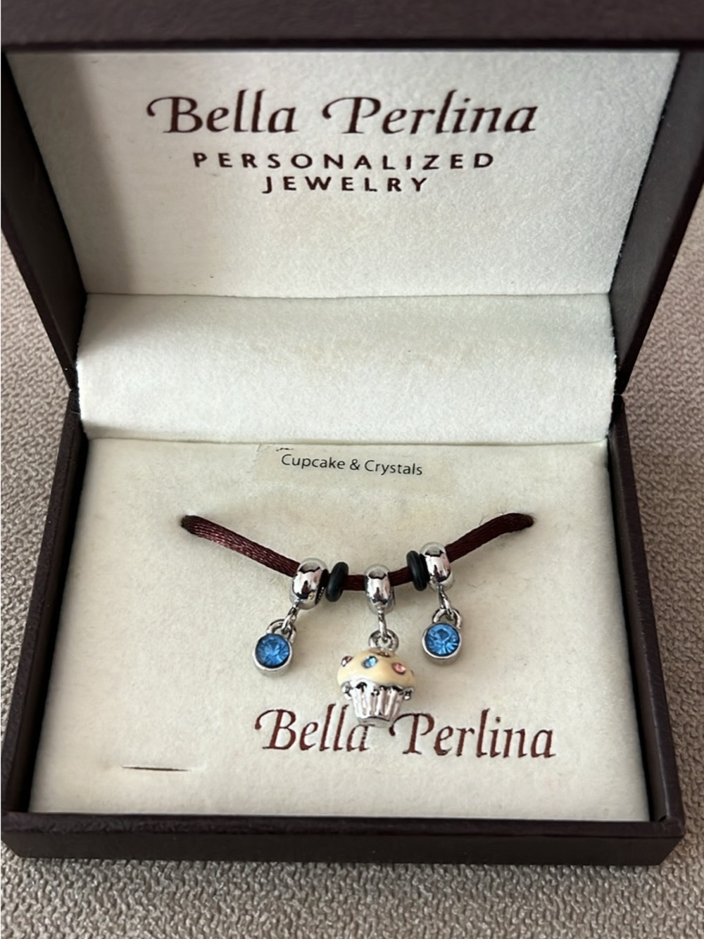 Bella Perlina Blue Crystal Cupcake Bracelet on Brown Cord